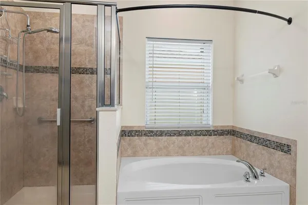 a bathroom with a bathtub and a shower