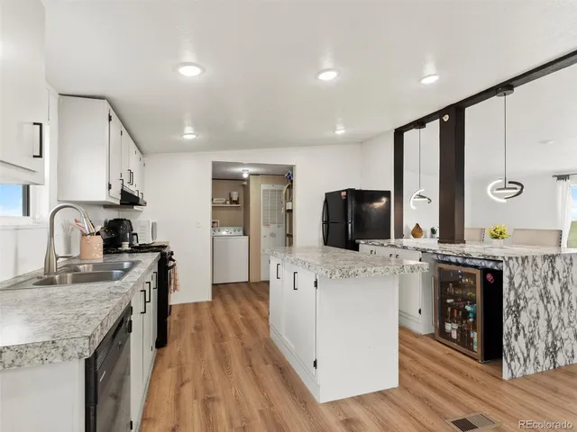 a large kitchen with stainless steel appliances granite countertop a stove and a sink