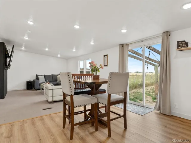 a dining room with furniture and wooden floor