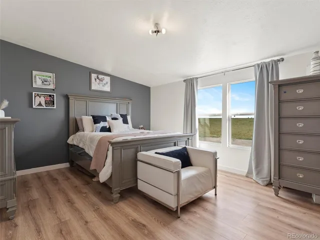 a spacious bedroom with a bed and a window