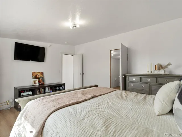 a bedroom with a bed and a flat screen tv