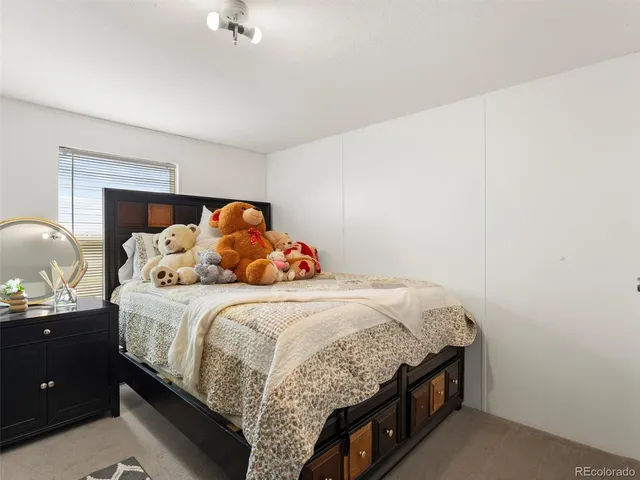 a bedroom with a bed and a dresser