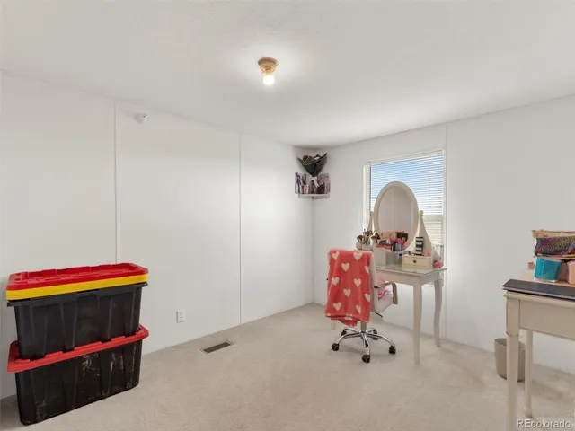 a living room with baby crib furniture and gym equipment