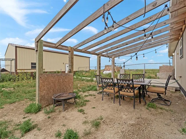 a view of a chairs and table in patio