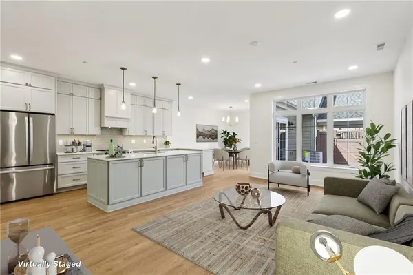 a living room with furniture and kitchen view