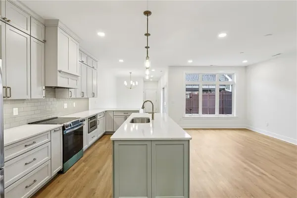 a kitchen with a sink stove and cabinets