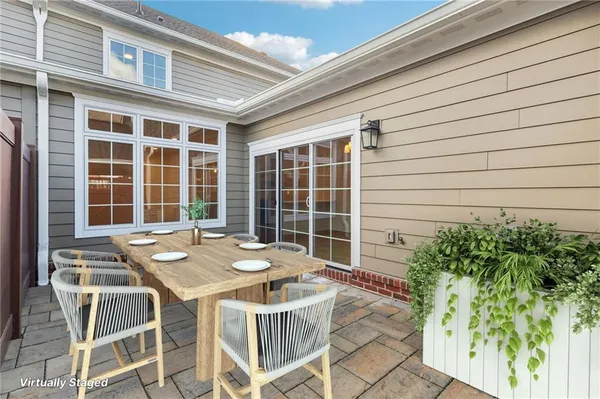 a table and chairs in front of a house