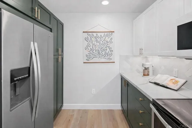 a kitchen with a refrigerator and a sink