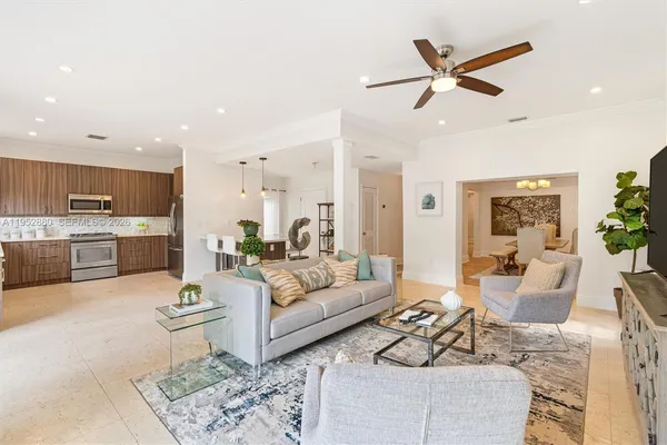 a living room with furniture and kitchen view