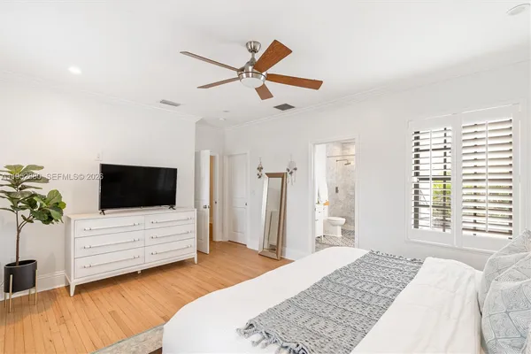 a bedroom with a bed window and flat screen tv