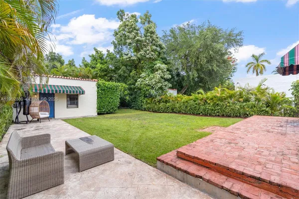 a front view of a house with a yard porch and outdoor seating