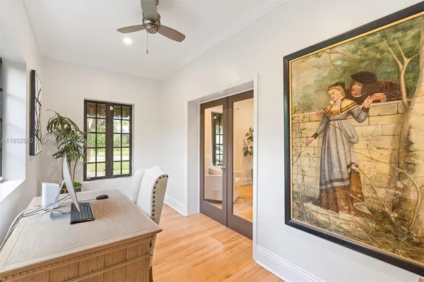 a dining room with wooden floor and a chandelier