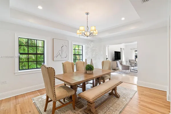 a living room with furniture a window and a dining table