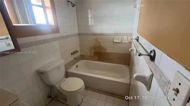 a bathroom with a toilet and a bathtub