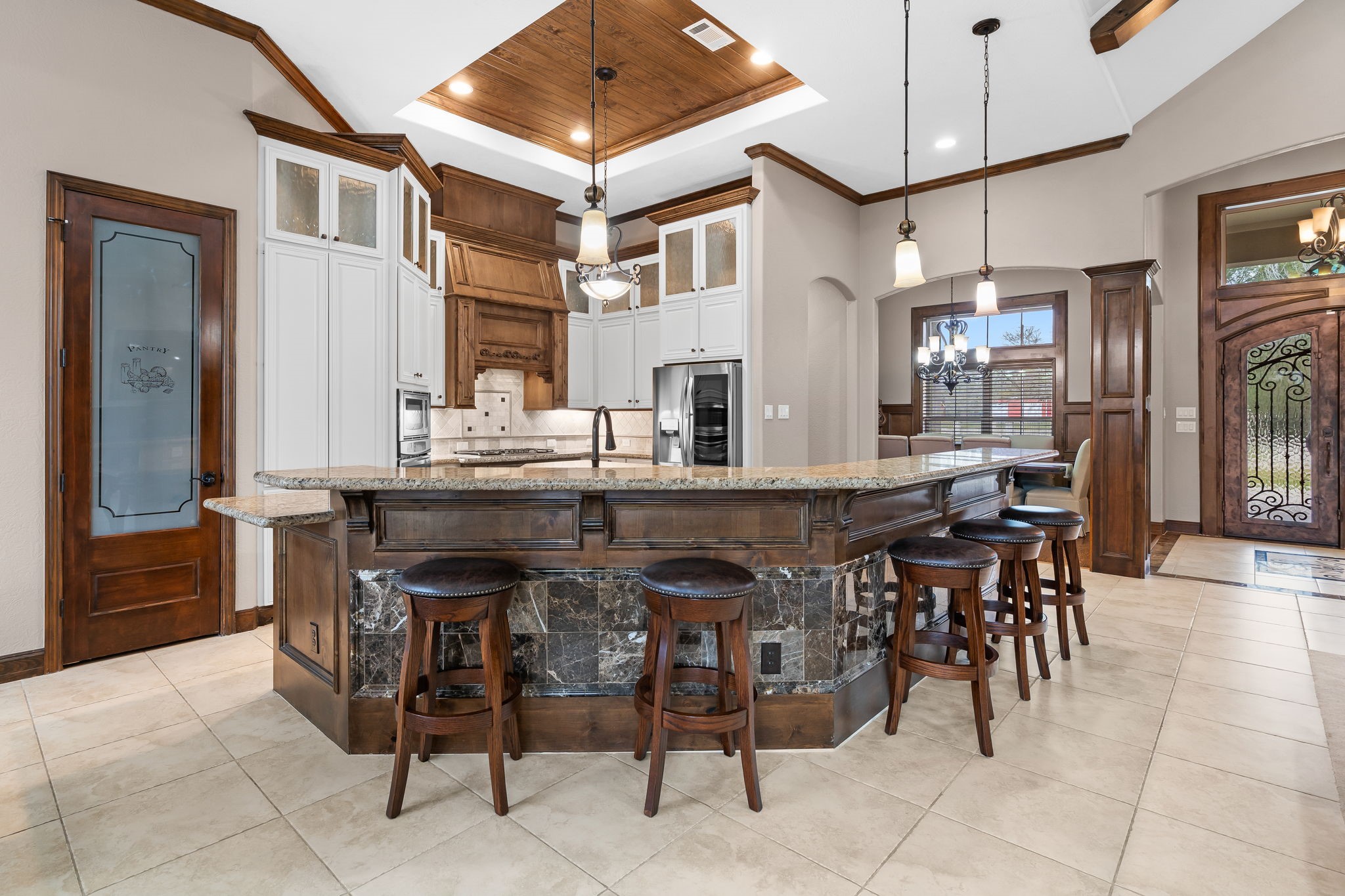 11009 Darby Loop Conroe, TX 77385 - Photo 27 of 43 The kitchen is well-equipped w/ double ovens, a gas cooktop, a trash compactor, lg island & butler’s pantry w/ wine fridge.