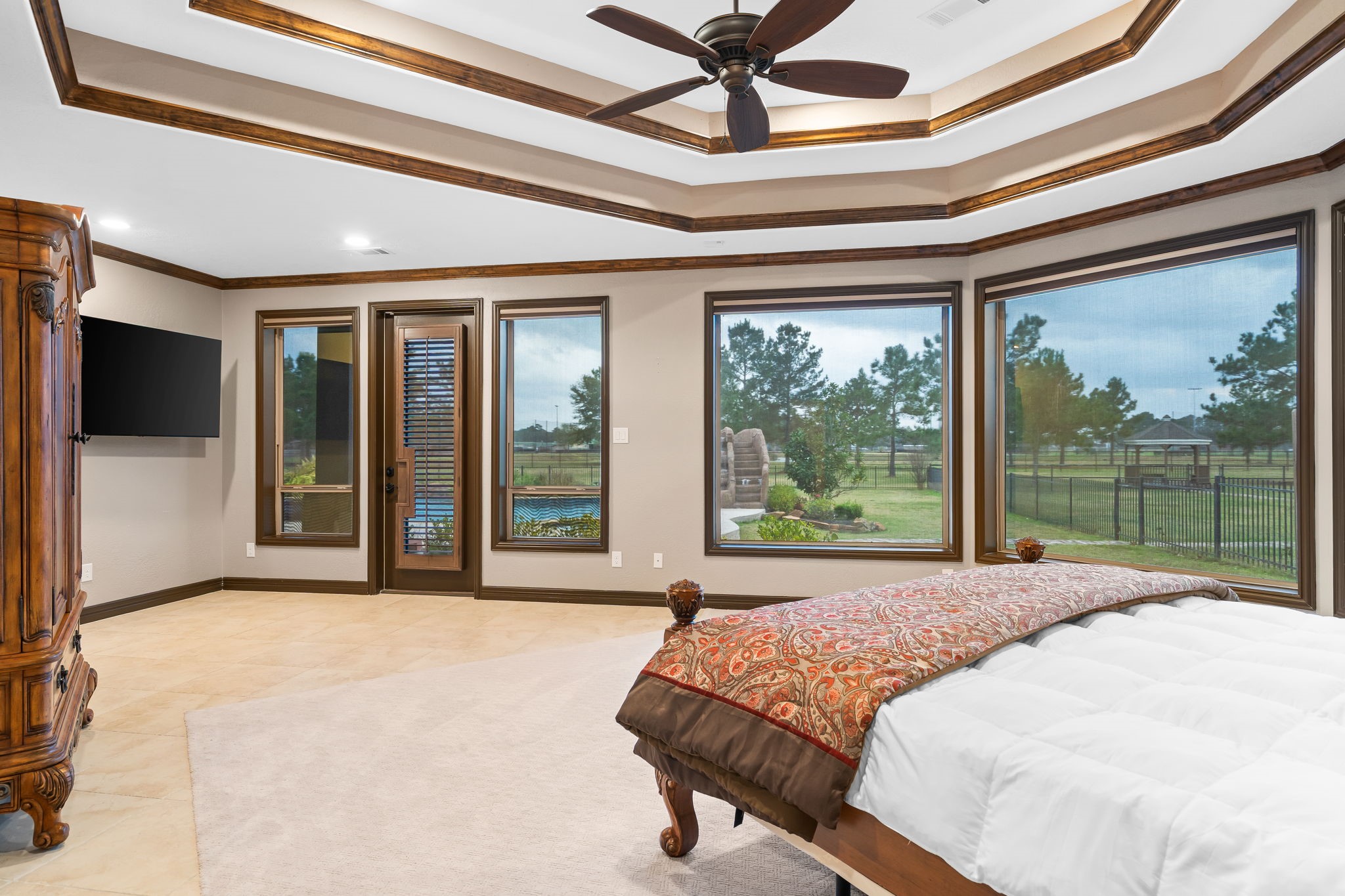 11009 Darby Loop Conroe, TX 77385 - Photo 32 of 43 The large primary bedroom offers a peaceful retreat with generous space, comfort, and direct access to the backyard.