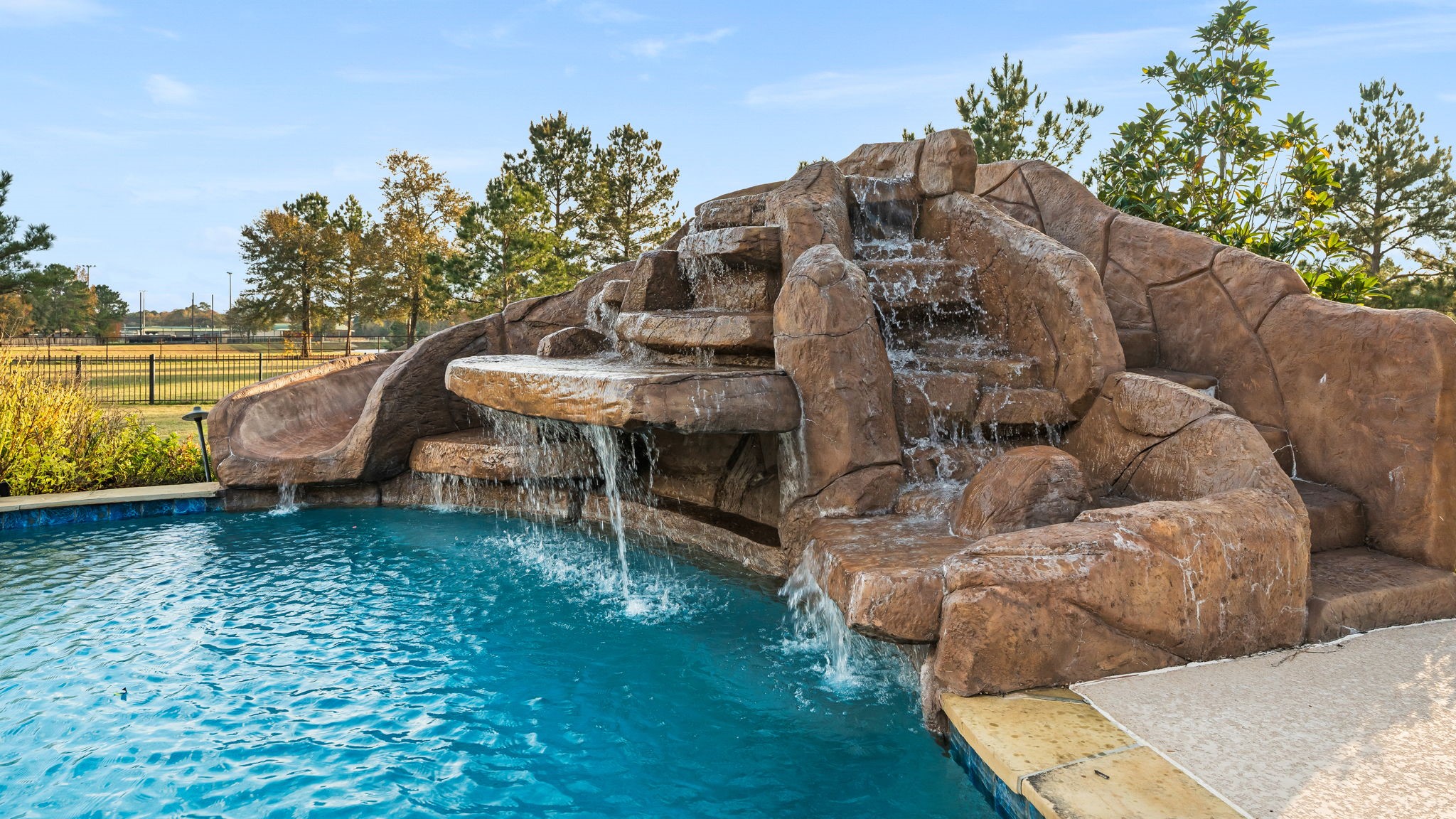 11009 Darby Loop Conroe, TX 77385 - Photo 10 of 43 Enjoy this amazing pool and slide.