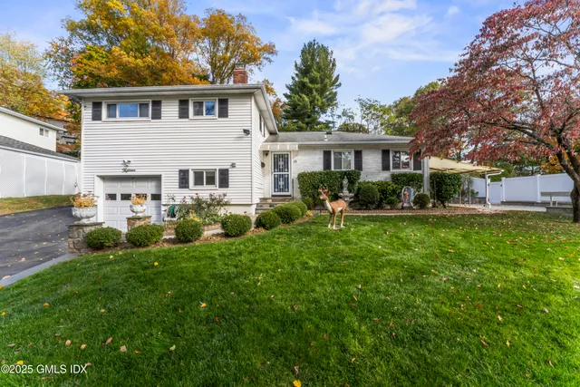 a view of a house with a yard porch and sitting area