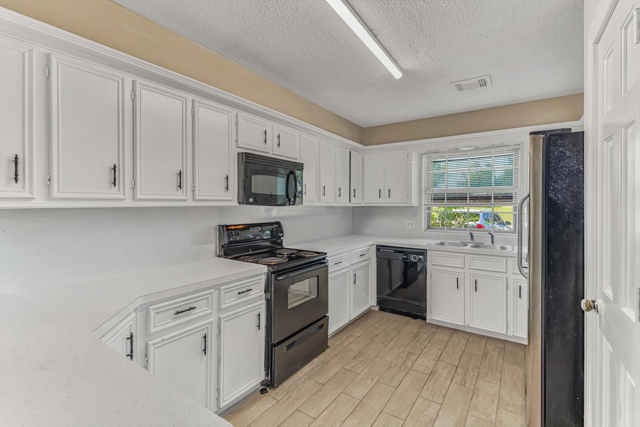 26822 Prairie Lane Katy, TX 77494 - Photo 16 of 30 a kitchen with granite countertop white cabinets and white appliances