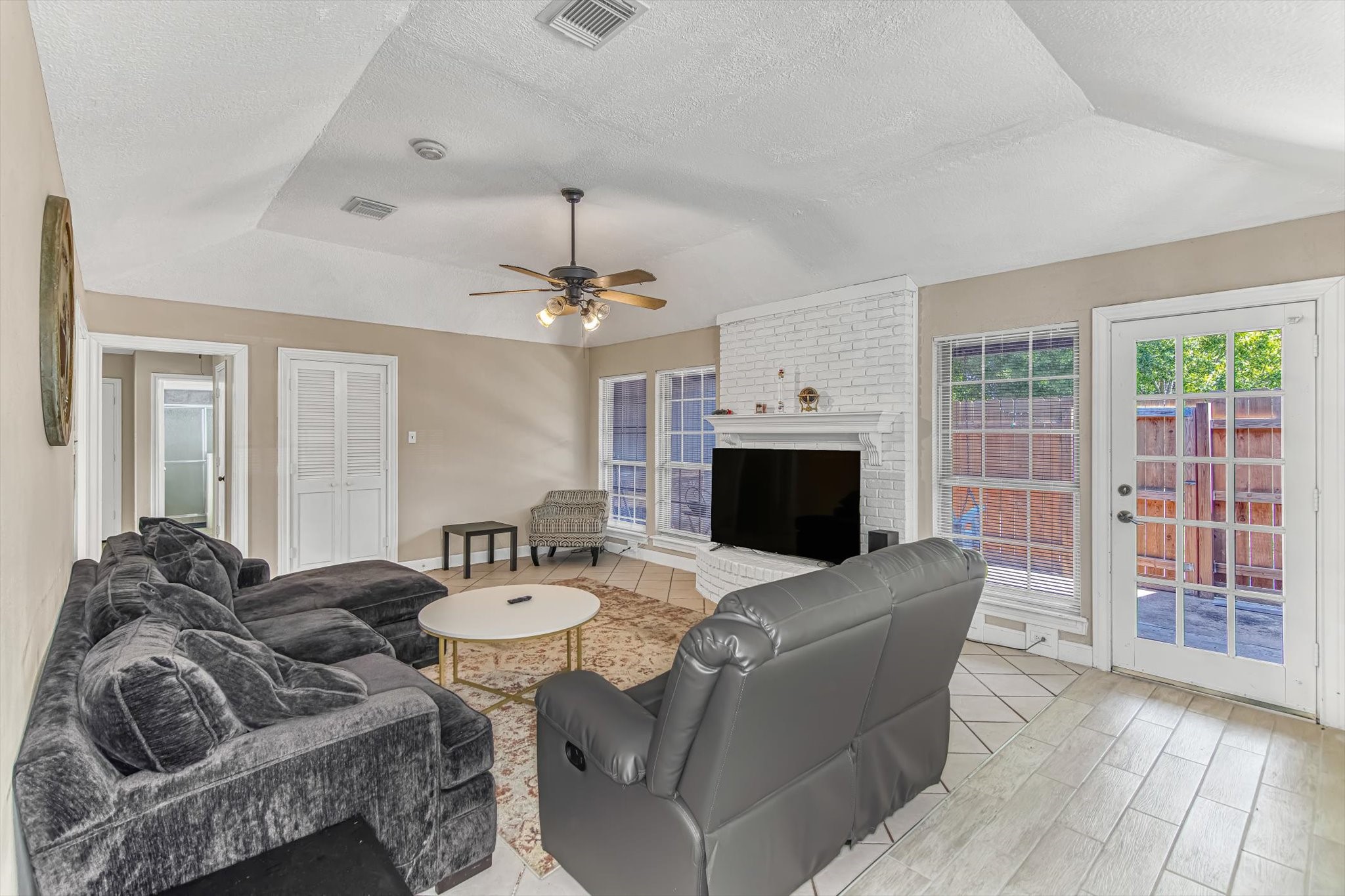 26822 Prairie Lane Katy, TX 77494 - Photo 19 of 30 a living room with furniture a fireplace and a flat screen tv