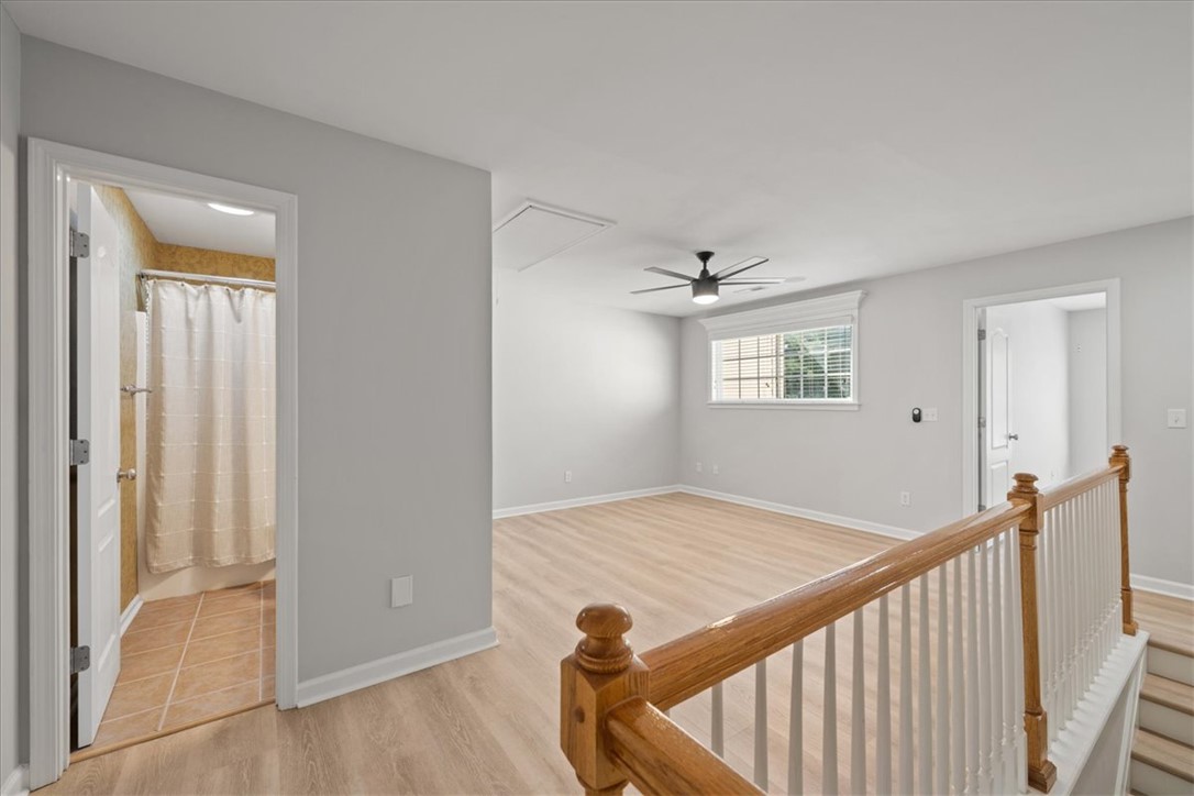 100 Shipyard Circle Anderson, SC 29621 - Photo 26 of 40 This bright, open space features hardwood flooring, a ceiling fan, and access to a bathroom.