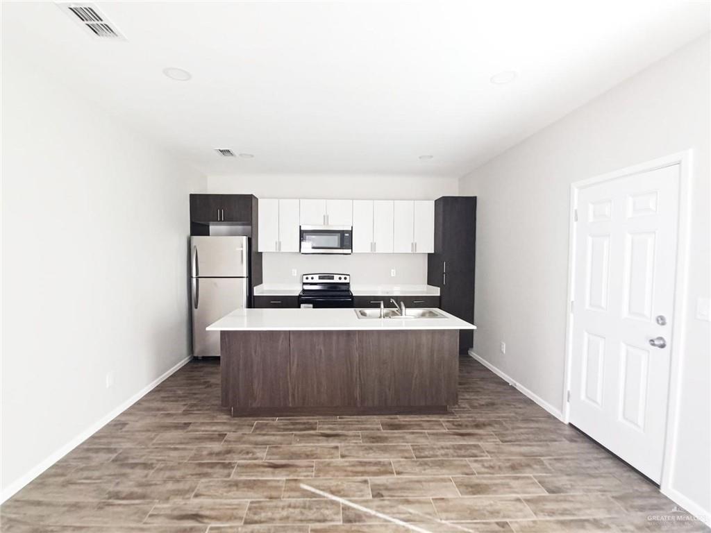 907 East Starr Road, Unit D Mercedes, TX 78570 - Photo 8 of 10 a view of kitchen with stainless steel appliances a refrigerator and a stove