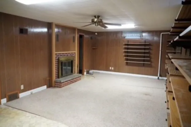 a view of an empty room with a fireplace