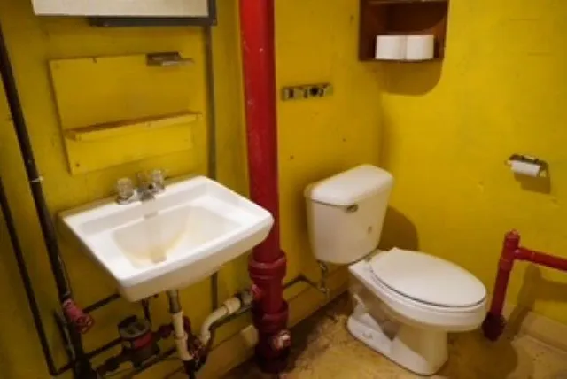 a white toilet sitting next to a bathroom sink