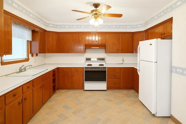 a kitchen with a refrigerator sink and cabinets