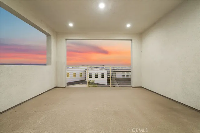 an empty room with furniture and a large window