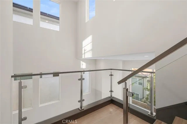 a view of staircase with white walls and a window