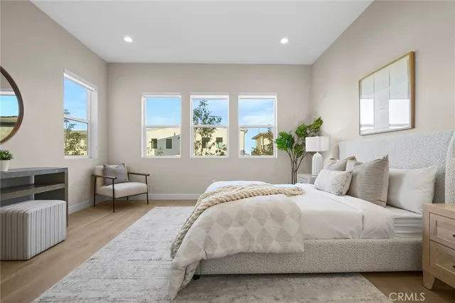 a bedroom with bed and a large window