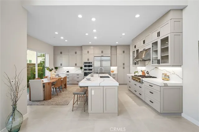 a large white kitchen with a large window