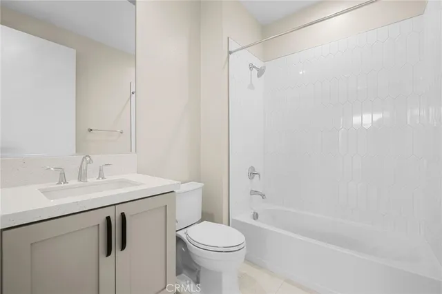 a bathroom with a sink toilet vanity and shower