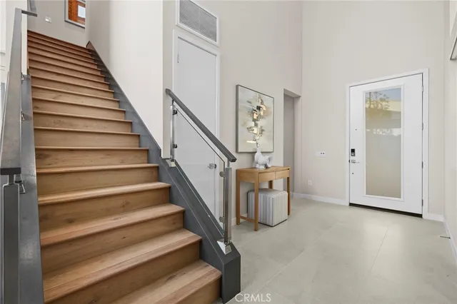 a view of entryway and hall with wooden floor