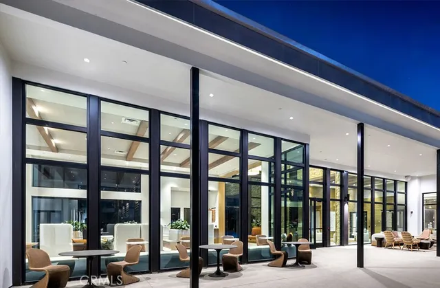 a view of a hall with living room and windows