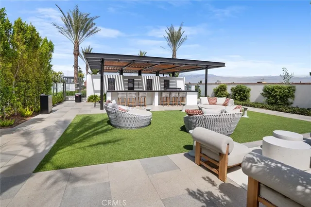 a view of a patio with couches chairs and a yard