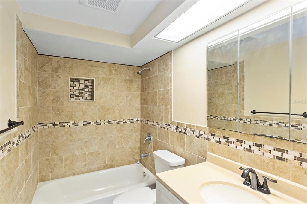 3128 Kilburn Road Holiday, FL 34691 - Photo 11 of 28 a bathroom with a bathtub and a sink