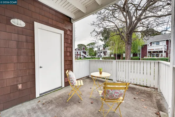 a view of a chair and tables in the patio