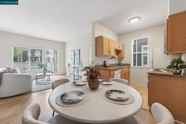 a kitchen with a table chairs stove and white cabinets