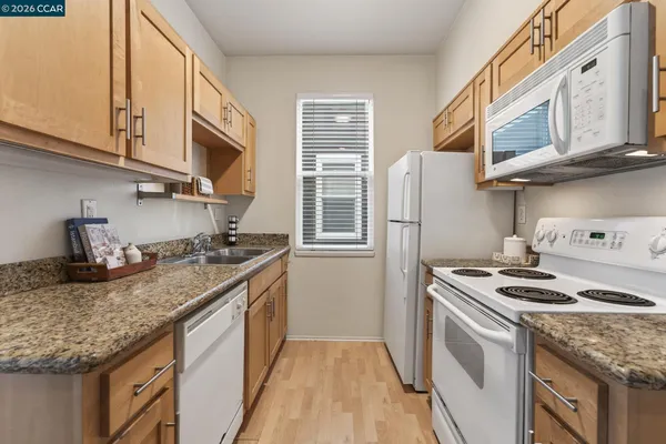 a kitchen with stainless steel appliances granite countertop a stove and a refrigerator