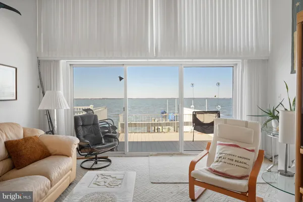a living room with furniture a flat screen tv and a window