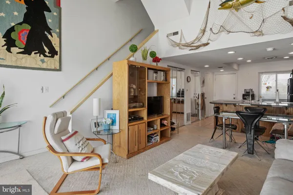 a view of a livingroom with furniture and a gym