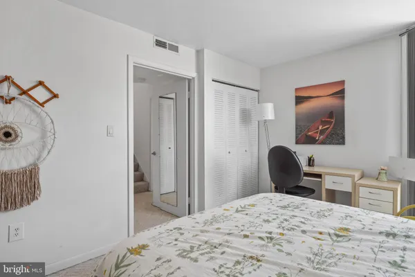 a bedroom with a bed and a dresser in it