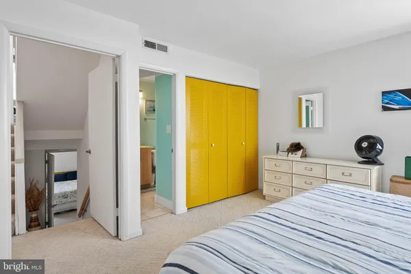 a bedroom with a bed and a view of bathroom