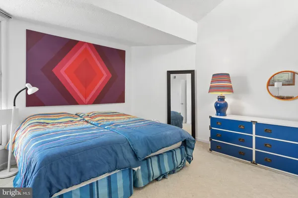 a bedroom with a bed and dresser