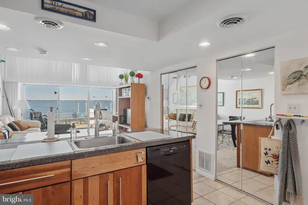 a kitchen with stainless steel appliances granite countertop a sink refrigerator and cabinets