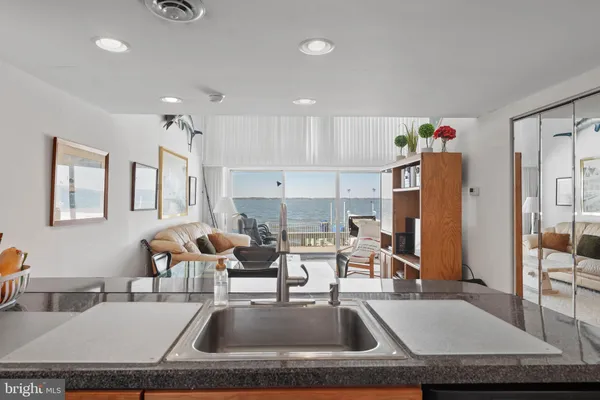 a kitchen with kitchen island a sink stove and refrigerator