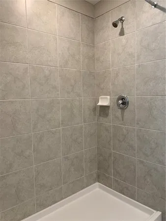 a bathroom with a granite countertop sink mirror vanity and toilet