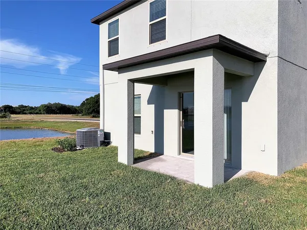 an aerial view of residential houses with outdoor space and river